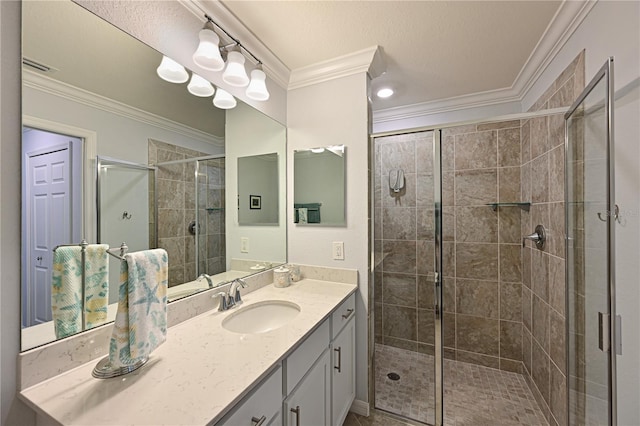 full bath featuring visible vents, vanity, a shower stall, and crown molding