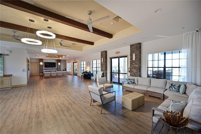 living room with wood finished floors, baseboards, visible vents, beam ceiling, and ceiling fan