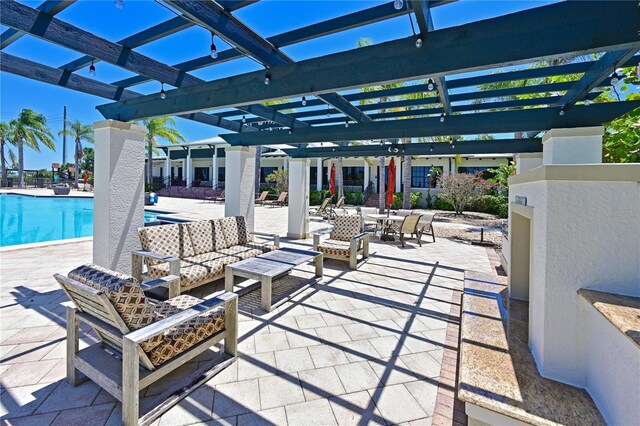 view of patio / terrace featuring a community pool, a pergola, and an outdoor hangout area