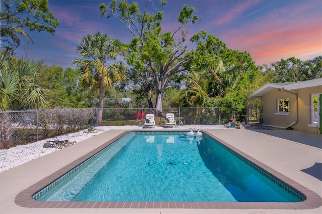 view of pool with a patio area, a fenced in pool, and fence