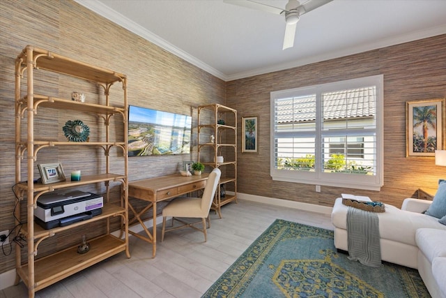 home office featuring ceiling fan, light wood-style floors, baseboards, and ornamental molding