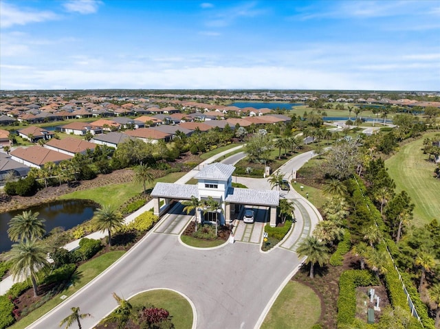 drone / aerial view with a residential view and a water view