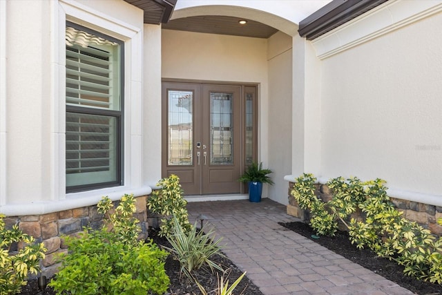 entrance to property with stucco siding and french doors