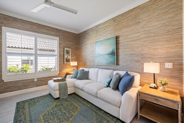 living room featuring wood finished floors, a ceiling fan, and ornamental molding