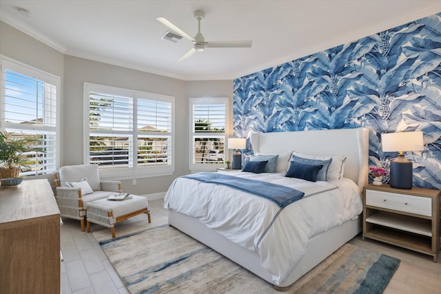 bedroom featuring visible vents, multiple windows, light wood-type flooring, and crown molding