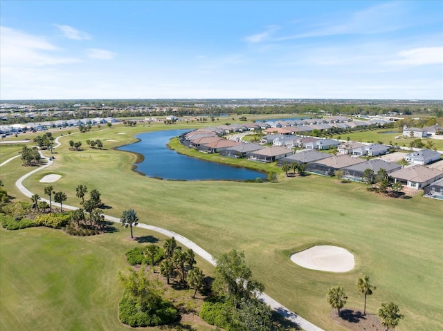 drone / aerial view featuring a residential view, golf course view, and a water view