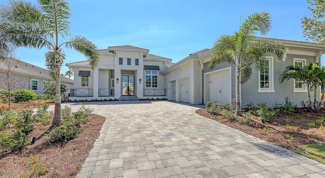 view of front of home with decorative driveway and an attached garage