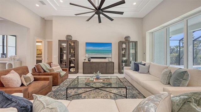 living area with visible vents, recessed lighting, carpet floors, a high ceiling, and baseboards