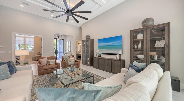 living area with recessed lighting, visible vents, a towering ceiling, and ceiling fan