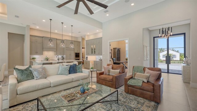 living room featuring visible vents, recessed lighting, and a towering ceiling