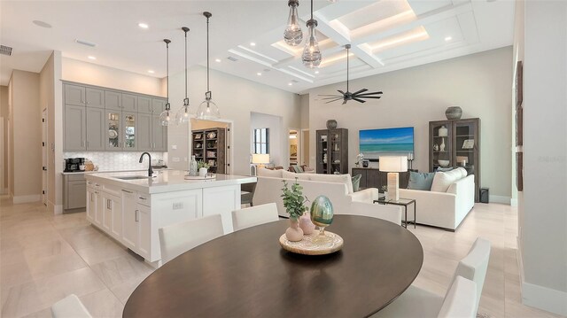 dining area featuring a ceiling fan, visible vents, coffered ceiling, a high ceiling, and recessed lighting