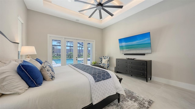 bedroom featuring ceiling fan, baseboards, french doors, a raised ceiling, and access to outside