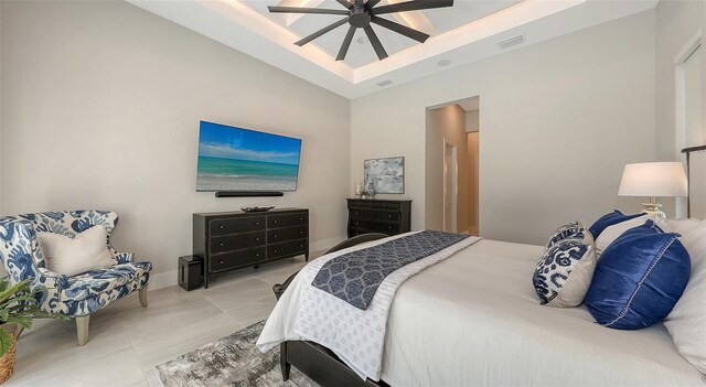 bedroom with visible vents, baseboards, ceiling fan, light tile patterned floors, and a high ceiling