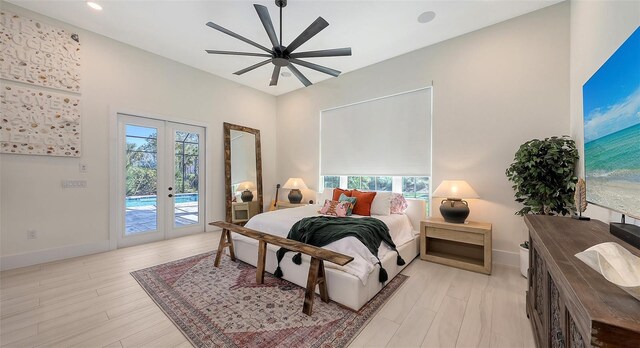 bedroom with access to exterior, multiple windows, french doors, and light wood-style floors