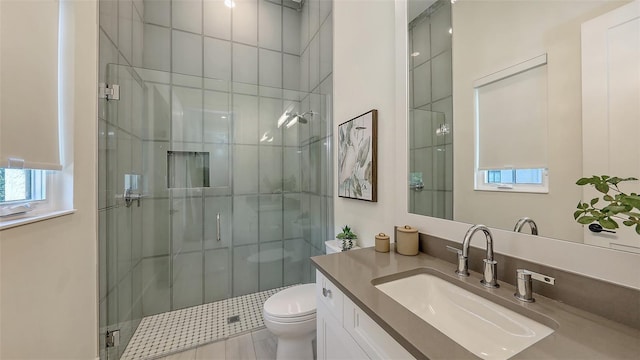 full bathroom featuring toilet, a stall shower, and vanity