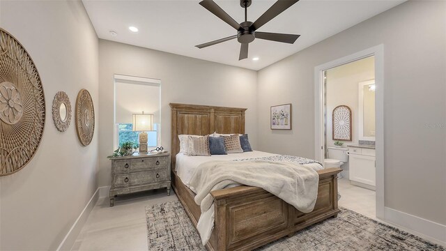 bedroom with ensuite bath, recessed lighting, and baseboards