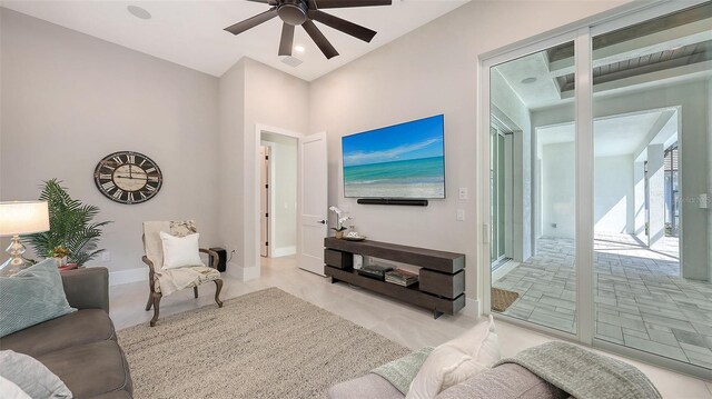 living room featuring visible vents, ceiling fan, and baseboards