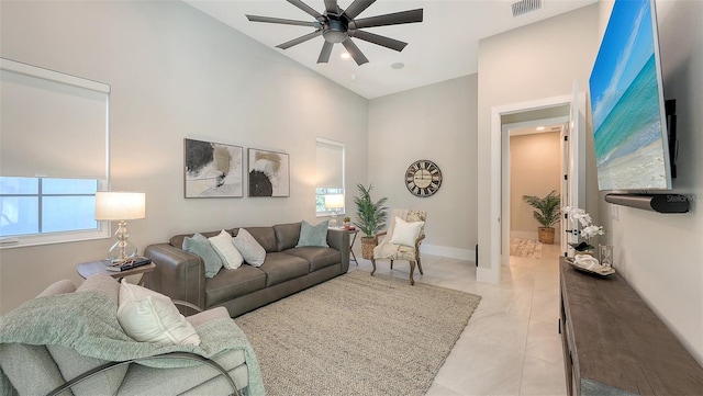 living room featuring light tile patterned floors, baseboards, visible vents, high vaulted ceiling, and ceiling fan