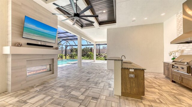 view of patio / terrace with area for grilling, a ceiling fan, a sink, glass enclosure, and a grill