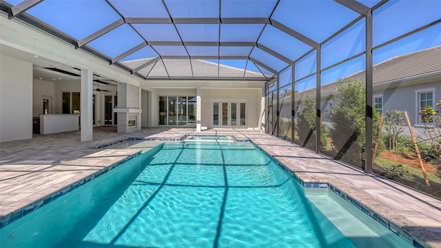 view of swimming pool featuring glass enclosure, french doors, a ceiling fan, and a patio