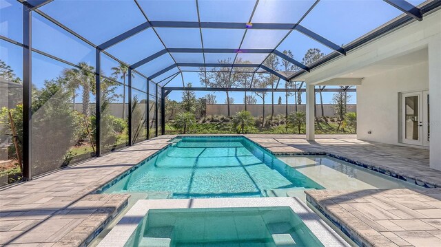 view of swimming pool featuring a pool with connected hot tub and a patio