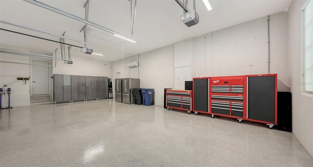 garage with a garage door opener and freestanding refrigerator