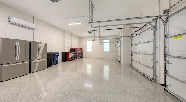 garage with a wall mounted air conditioner, a garage door opener, and freestanding refrigerator