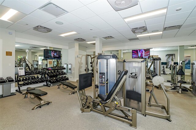 gym with a drop ceiling and visible vents