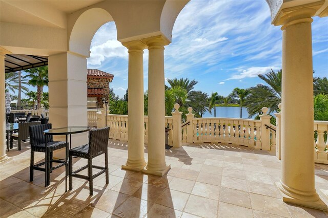 view of patio / terrace with outdoor dining area and a water view