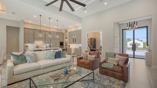 8348 Catamaran Cir, Lakewood Ranch, FL 34202 - living area with light tile patterned flooring, visible vents, a high ceiling, and ceiling fan with notable chandelier
