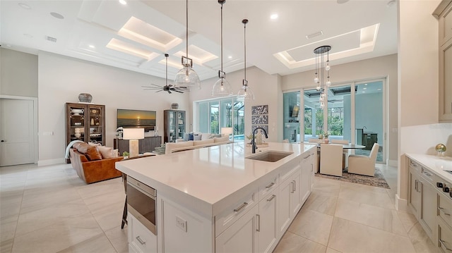 8348 Catamaran Cir, Lakewood Ranch, FL 34202 - kitchen featuring a sink, light countertops, a ceiling fan, coffered ceiling, and hanging light fixtures