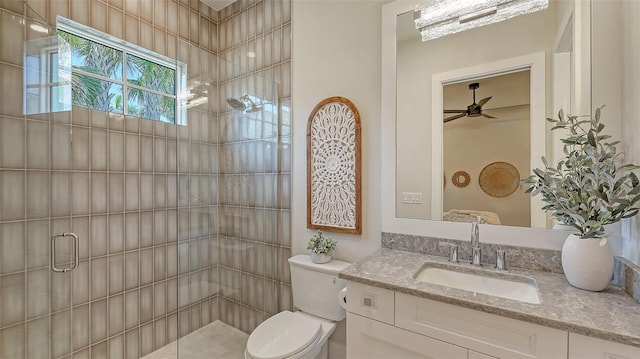 8348 Catamaran Cir, Lakewood Ranch, FL 34202 - bathroom featuring vanity, toilet, a shower stall, and a ceiling fan