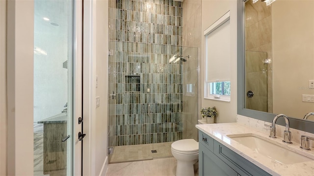 8348 Catamaran Cir, Lakewood Ranch, FL 34202 - full bathroom featuring vanity, toilet, tile patterned flooring, and a stall shower