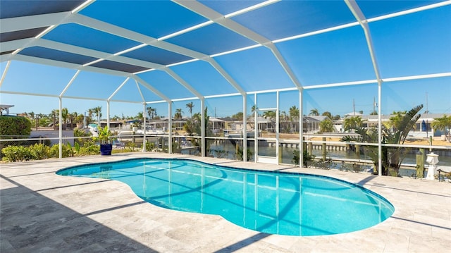 pool featuring a lanai, a patio area, a water view, and a boat dock