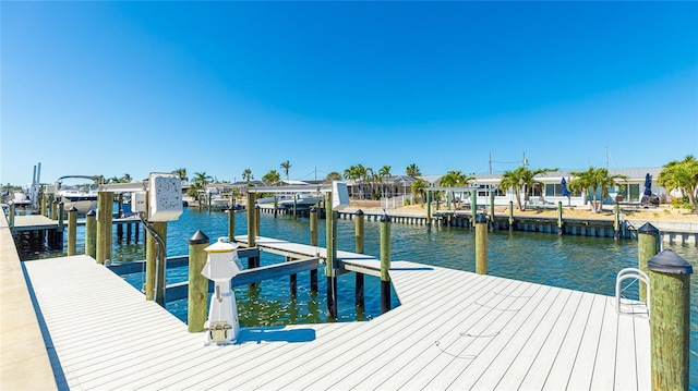 dock area with a water view and boat lift