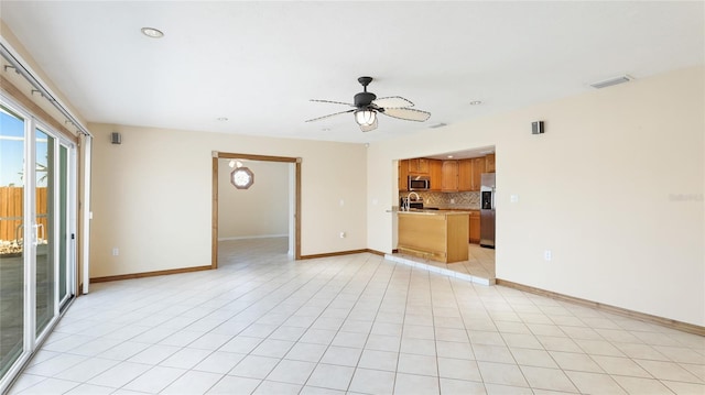 unfurnished living room with visible vents, a ceiling fan, recessed lighting, light tile patterned floors, and baseboards