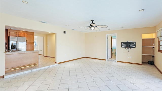 unfurnished living room featuring a ceiling fan, baseboards, visible vents, light tile patterned flooring, and recessed lighting