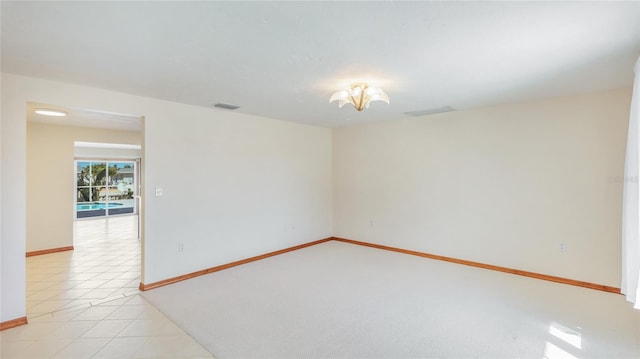 unfurnished room with light tile patterned floors, baseboards, and visible vents