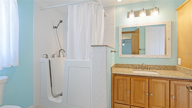 full bath featuring a tub, toilet, vanity, and a shower with curtain