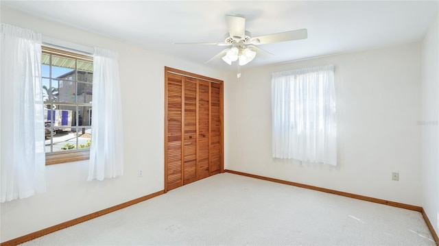 unfurnished bedroom featuring baseboards, a closet, and carpet floors