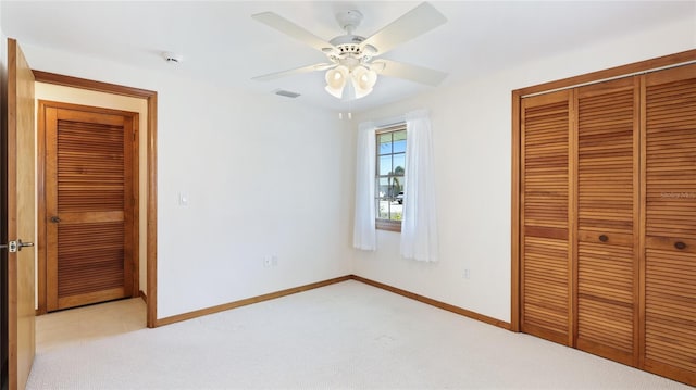 unfurnished bedroom featuring visible vents, ceiling fan, baseboards, light carpet, and a closet