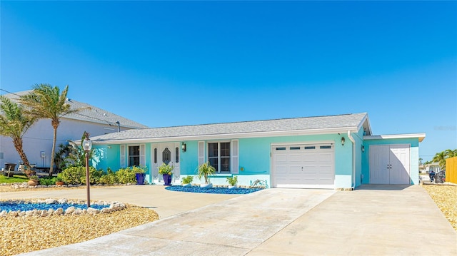 ranch-style home with an attached garage, driveway, and stucco siding