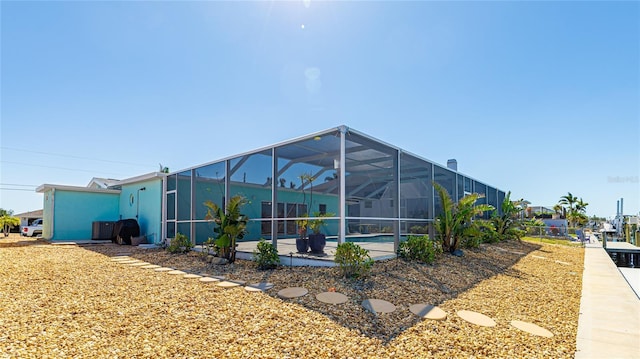 view of property exterior with a lanai and a patio