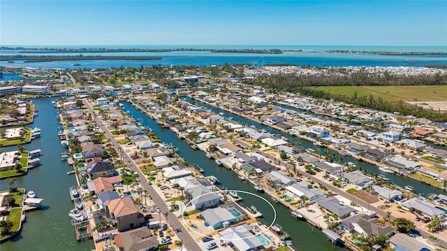 drone / aerial view with a residential view and a water view