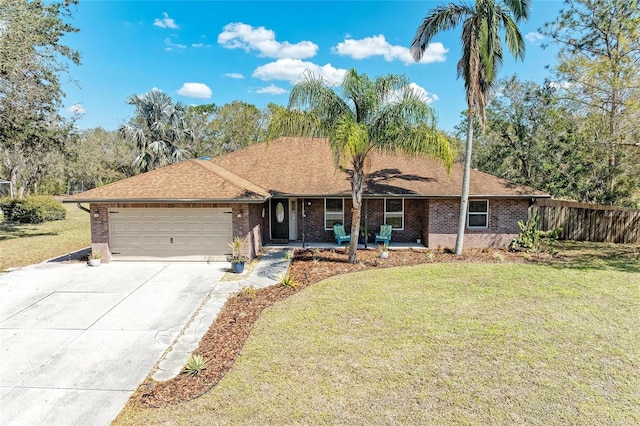 1127 133rd St E, Bradenton, FL 34212 - single story home featuring a front lawn, an attached garage, brick siding, and concrete driveway