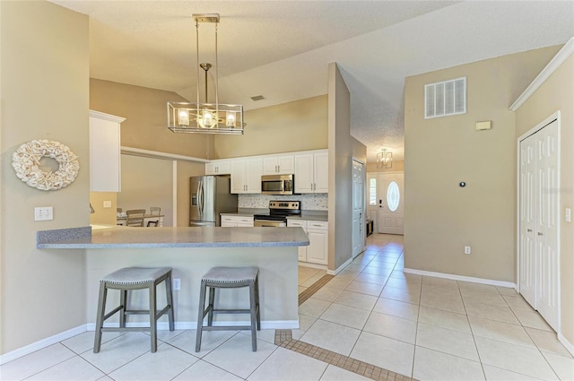 1127 133rd St E, Bradenton, FL 34212 - kitchen featuring light tile patterned flooring, visible vents, tasteful backsplash, and stainless steel appliances