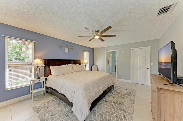 1127 133rd St E, Bradenton, FL 34212 - bedroom with light tile patterned flooring, a ceiling fan, a textured ceiling, baseboards, and visible vents