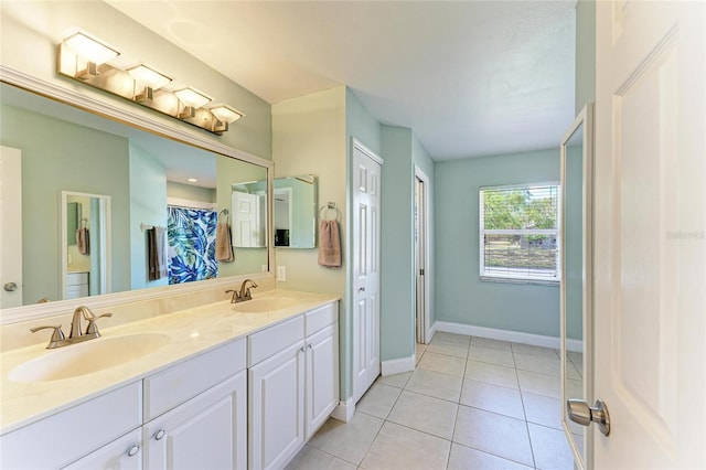1127 133rd St E, Bradenton, FL 34212 - bathroom featuring double vanity, tile patterned flooring, a sink, and baseboards
