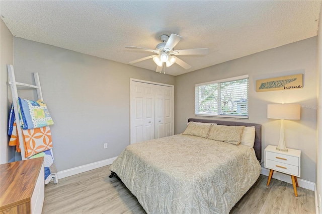 1127 133rd St E, Bradenton, FL 34212 - bedroom with a closet, a textured ceiling, baseboards, ceiling fan, and wood finished floors
