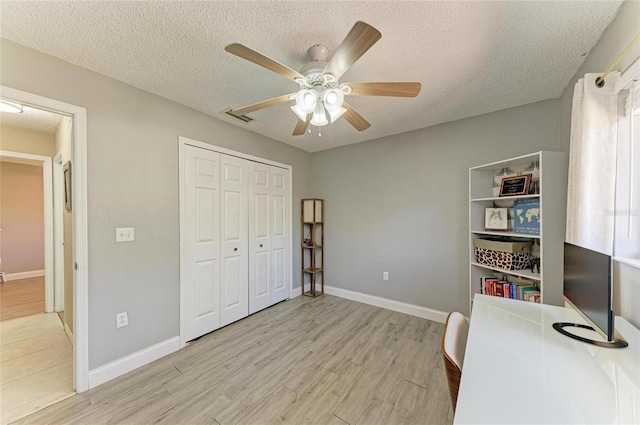 1127 133rd St E, Bradenton, FL 34212 - office space featuring a textured ceiling, light wood-style flooring, and a ceiling fan
